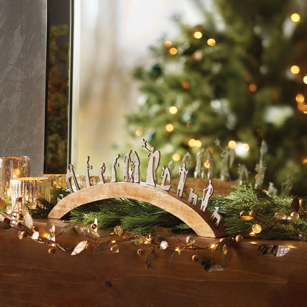 Artist, Wendy Wiinanen, crafts memorable moments of intrigue from mango wood and aluminium. This enchanting arch display showcases the characters of the traditional Nativity scene with simplistic elegance.