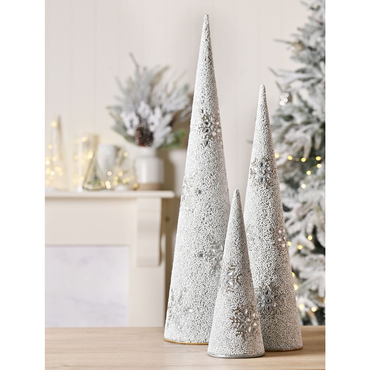 Its large size makes it a striking focal point on mantels, shelves, or as a centrepiece on tabletops. Whether displayed alone or alongside other decorations, this cone tree brings a touch of holiday cheer to any space.