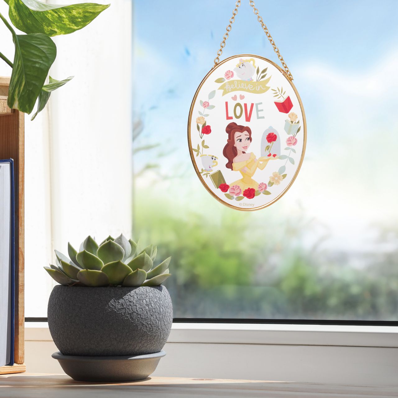 Illuminate your garden with the Belle Suncatcher by Disney garden. Featuring the beloved Beauty and the Beast princess, this charming suncatcher dazzles in the sunlight, adding a touch of enchantment to any outdoor space. Ideal for Disney fans and garden enthusiasts, it brings a magical sparkle to your view.