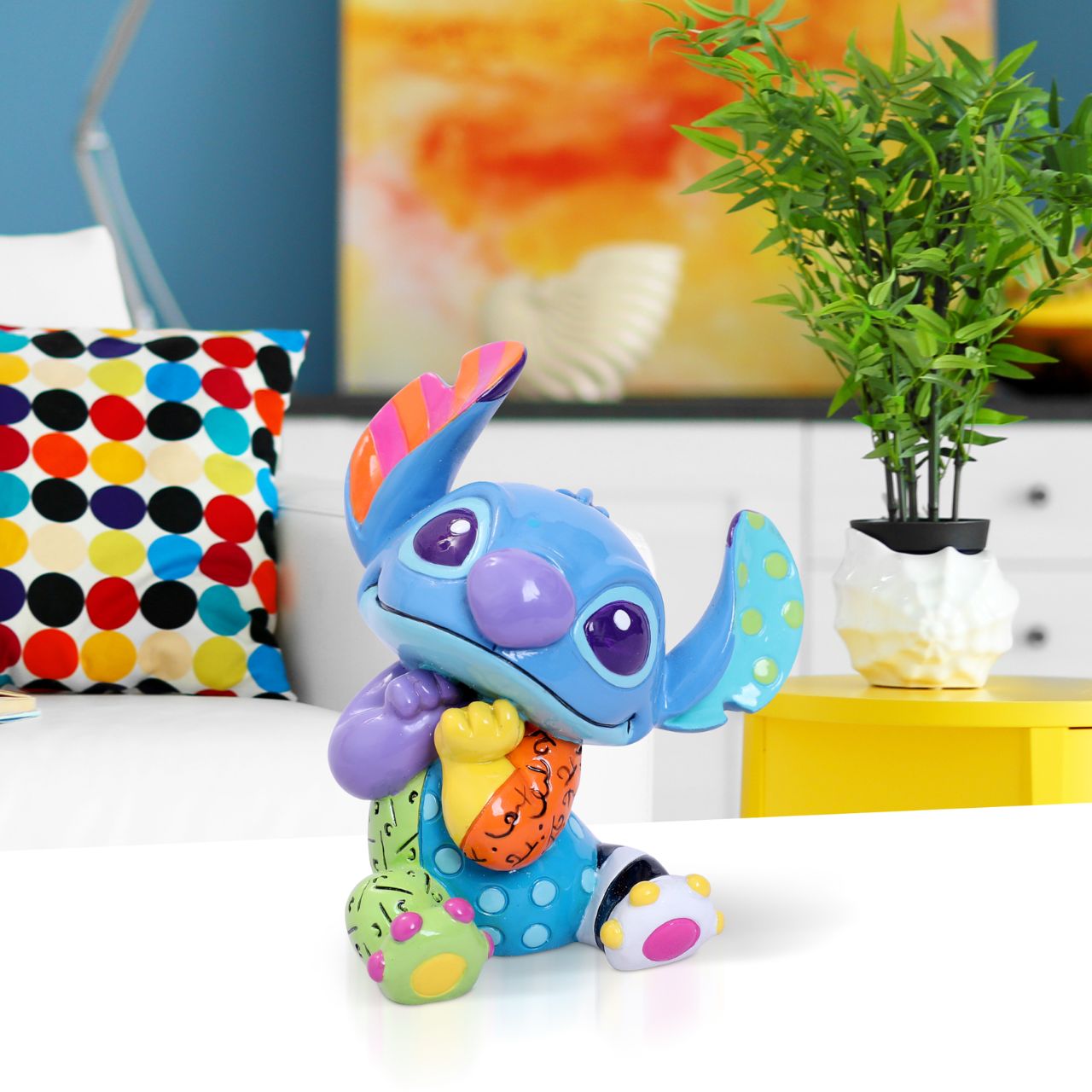 Experiment 626 was designed to be the ultimate bioweapon, but he discovered a gentler life after crash-landing in Hawaii and being adopted by a little girl named Lilo. Stitch's blue fur has taken on a vivid array of colours as designed by Romero Britto.