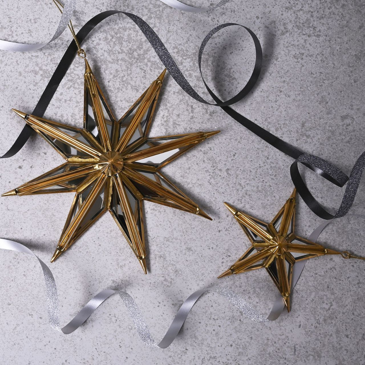 Celestial Gold Mirror Star Tree Decoration Large  A gold mirror star tree decoration by THE SEASONAL GIFT CO.  This gorgeous decoration will stand out amongst the branches on the Christmas tree.