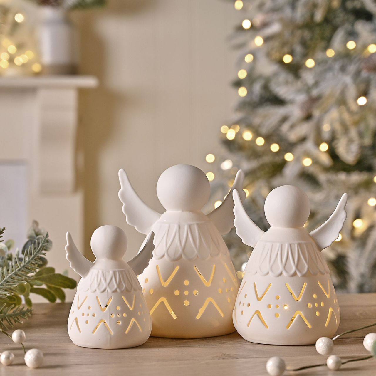 Illuminate your retail space with the Ceramic Light Up LED Angel - Large by The Seasonal Gift Co. This enchanting angel radiates warmth and serenity, perfect for adding a touch of heavenly charm to any display.