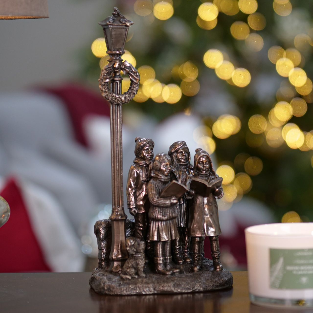 Genesis Ireland Christmas Carol Singers  A stunning ornament that is sure to bring festive cheer to your home. A beautiful bronze coloured Christmas decoration, by Genesis Ireland. Depicting a group of carol singers spreading the joy of Christmas. Let the magic of Christmas fill your home with this gorgeous sculpture for many years to come.