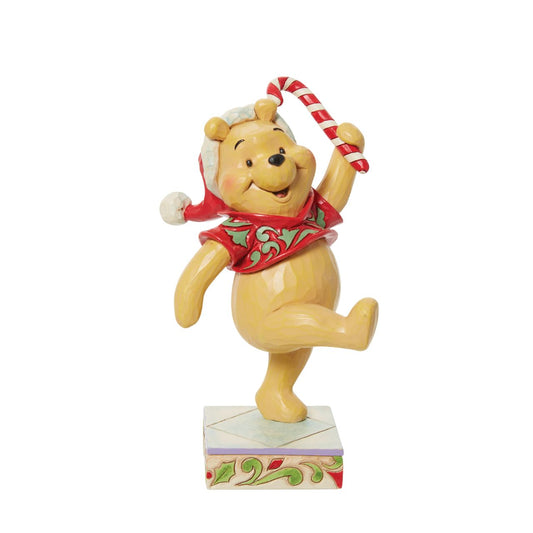 Disney Traditions Christmas Holiday Pooh Figurine  Disney's super cute Winne the Pooh is in the festive mood. This Christmas themed piece has been designed by award winning artist Jim Shore.