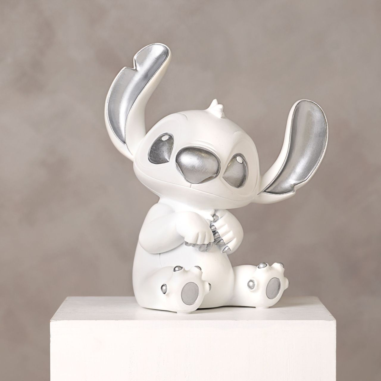 Disney 100th Anniversary Stitch Money Bank  A Stitch money box from DISNEY.  This substantial money box captures the character in a playful, inquisitive pose.