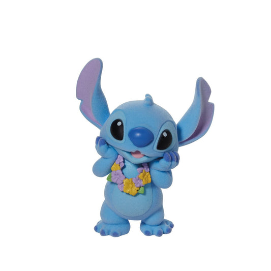 This super cute Stitch is dressed in a pretty lei, ready to get in the party mood. What makes him even more special is that this Stitch is flocked, which makes him fuzzy to touch. Disney's favourite alien is the perfect addition to any collection and this one is sure to make an impact wherever he goes. Comes in fully branded window box.