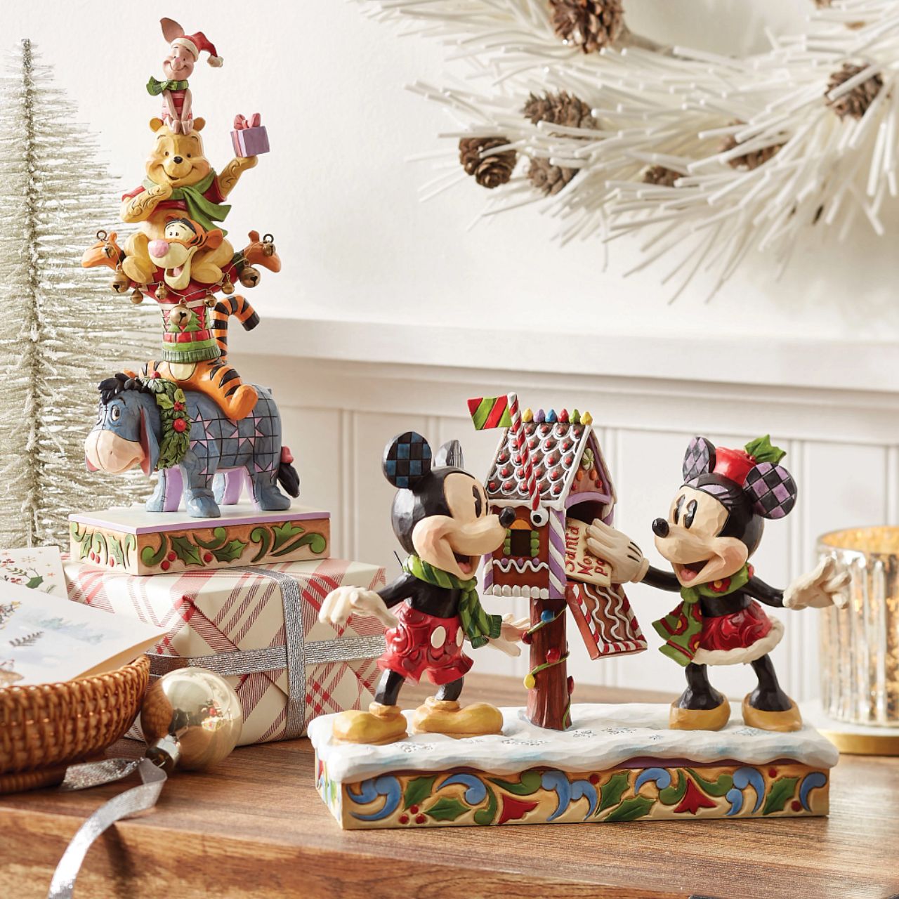 Mickey & Minnie Mouse are in the Christmas Spirit with Disney Traditions by Jim Shore. A beautiful, festive figurine featuring the iconic couple posting their Christmas letter off to Santa. Hand carved and hand painted. Comes in a fully branded gift box.