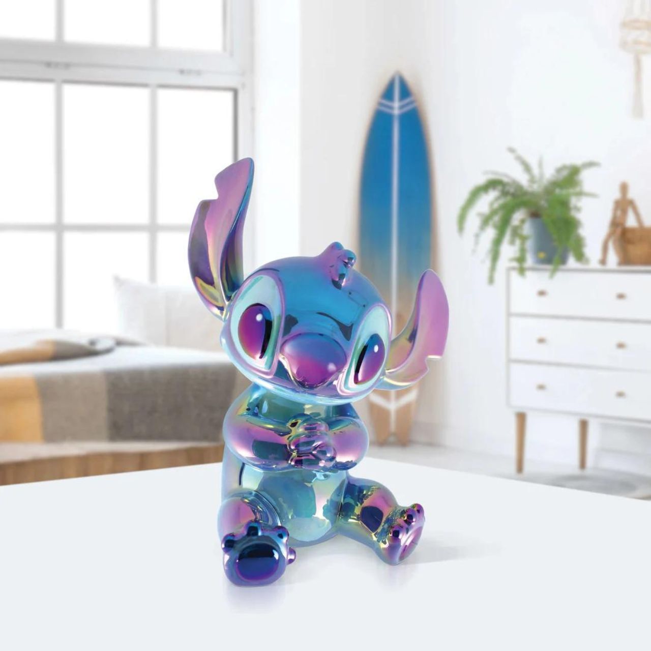 Make saving fun with the Stitch Ceramic Money Bank by Disney Showcase. It is the perfect, practical décor piece for Disney fans of all ages. At 19 cm tall with a dazzling blue, iridescent finish this piece is guaranteed to catch the attention of all that see it and will add the Disney magic to any home.