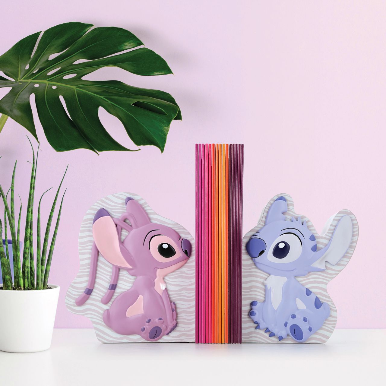 Let Stitch and Angel guard your tales. Introducing Disney's Stitch and Angel Bookends. These adorable characters create a delightful scene while showcasing your favourite stories. Add a touch of mischief and love to your shelves with these charming bookends.