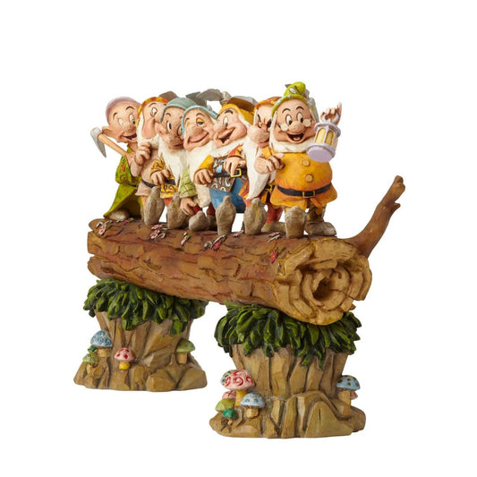 Homeward Bound captures a very memorable scene from the classic Snow White animation; the lovable 7 Dwarfs return home to find an unexpected house guest: a sleeping Princess. Designed by award winning artist and sculptor, Jim Shore for the Disney Traditions brand. The figurine is made from cast stone.