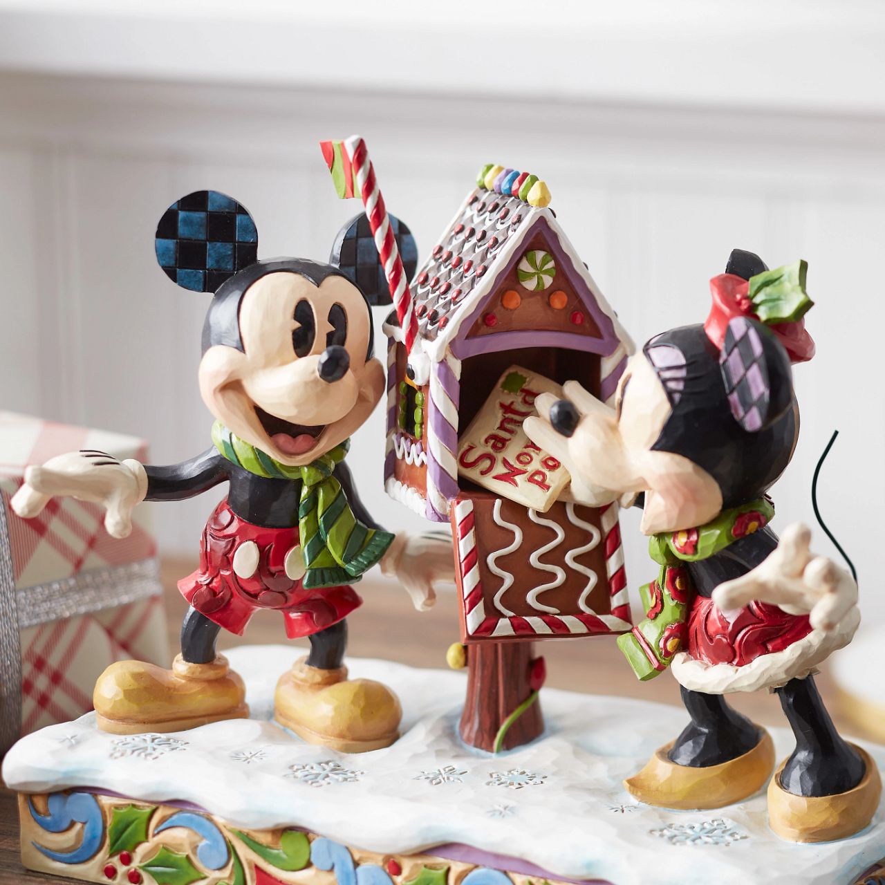 Mickey & Minnie Mouse are in the Christmas Spirit with Disney Traditions by Jim Shore. A beautiful, festive figurine featuring the iconic couple posting their Christmas letter off to Santa. Hand carved and hand painted. Comes in a fully branded gift box.