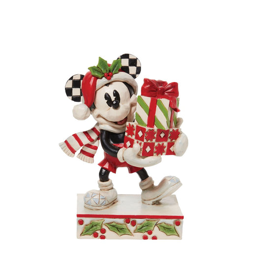 Disney comes home for the holidays with this festive figurine by Jim Shore. Donning a candy cane striped scarf, Mickey wears a neighbourly smile as he carries a towering stack of presents. The cheerful mouse boasts a holly brimmed Santa hat.