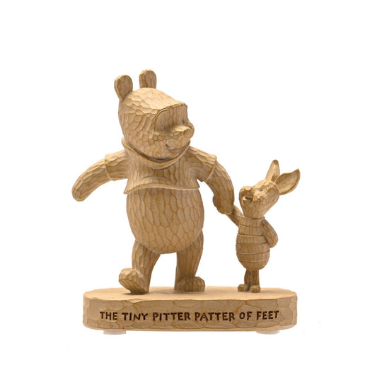 Winnie the Pooh Wood Effect Figurine "The Tiny Pitter Patter of Feet"  Bring some Disney magic to the life of your loved ones with this wonderful Pooh & Piglet figurine. Measures 12cms in height and has a width of 10cms.