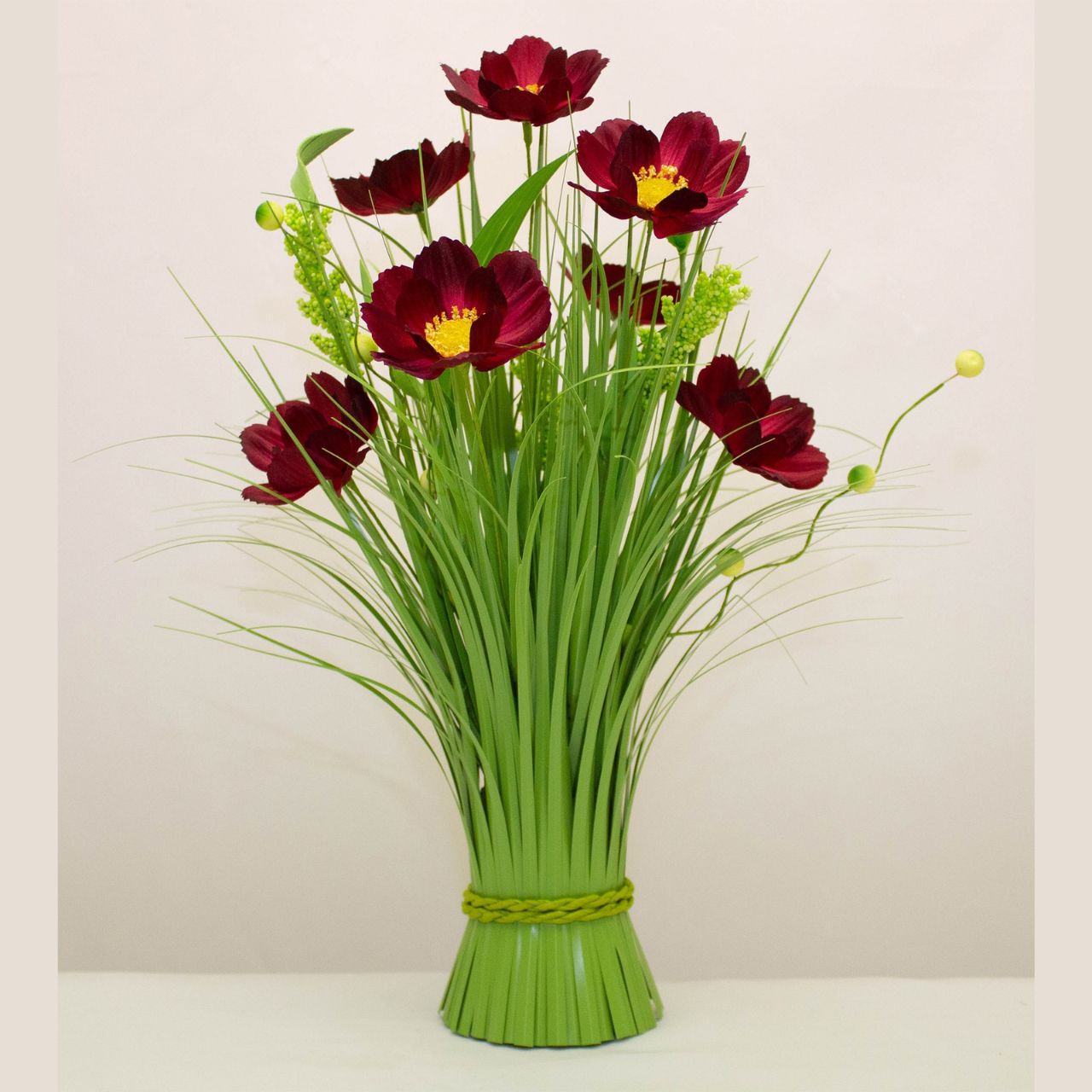 Burgundy Daisy Mini Floral Sheaf 40cm  This Enchante Burgundy Daisy Mini Floral Sheaf measures 40cm and features vibrant burgundy daisies. Handcrafted with high-quality, this miniature floral arrangement adds a touch of elegance to any space. Perfect for home decor, weddings, or special events. Bring the beauty of nature indoors with this stunning floral sheaf.