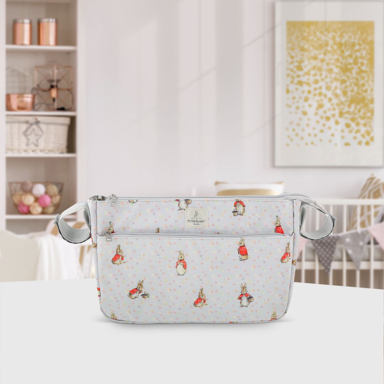 This Flopsy pram organiser will keep all your essentials and valuables close at hand when you are out and about with your little one. This functional and fashionable bag easily attaches to your pram with the Velcro side straps - perfect for quick trips out and about. Featuring Flopsy on an easily wipe-down PU fabric, off-set against pastel splashes of colour on a cool grey background makes this the perfect baby shower gift for any parents-to-be.