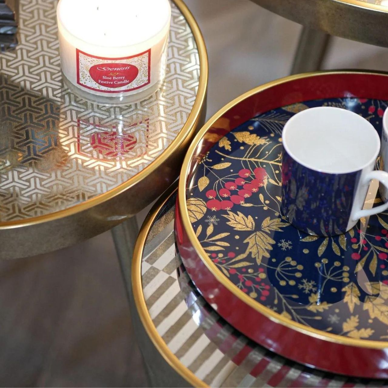 Christmas Forest Pine Tray by Mindy Brownes Interiors  A stunning circular tray, with a berry red surround, gold rim and a navy and gold foliage design in the center with pops of glitter. An ideal styling accessory this Christmas season.