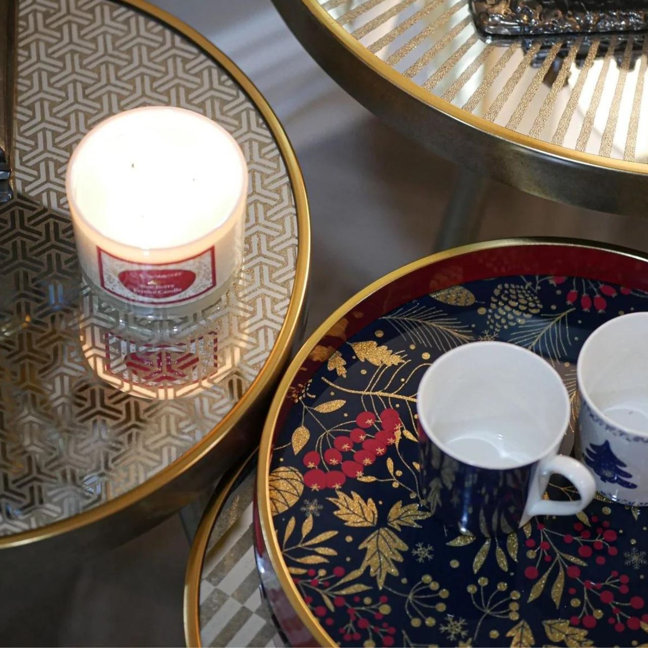 Christmas Forest Pine Tray by Mindy Brownes Interiors  A stunning circular tray, with a berry red surround, gold rim and a navy and gold foliage design in the center with pops of glitter. An ideal styling accessory this Christmas season.