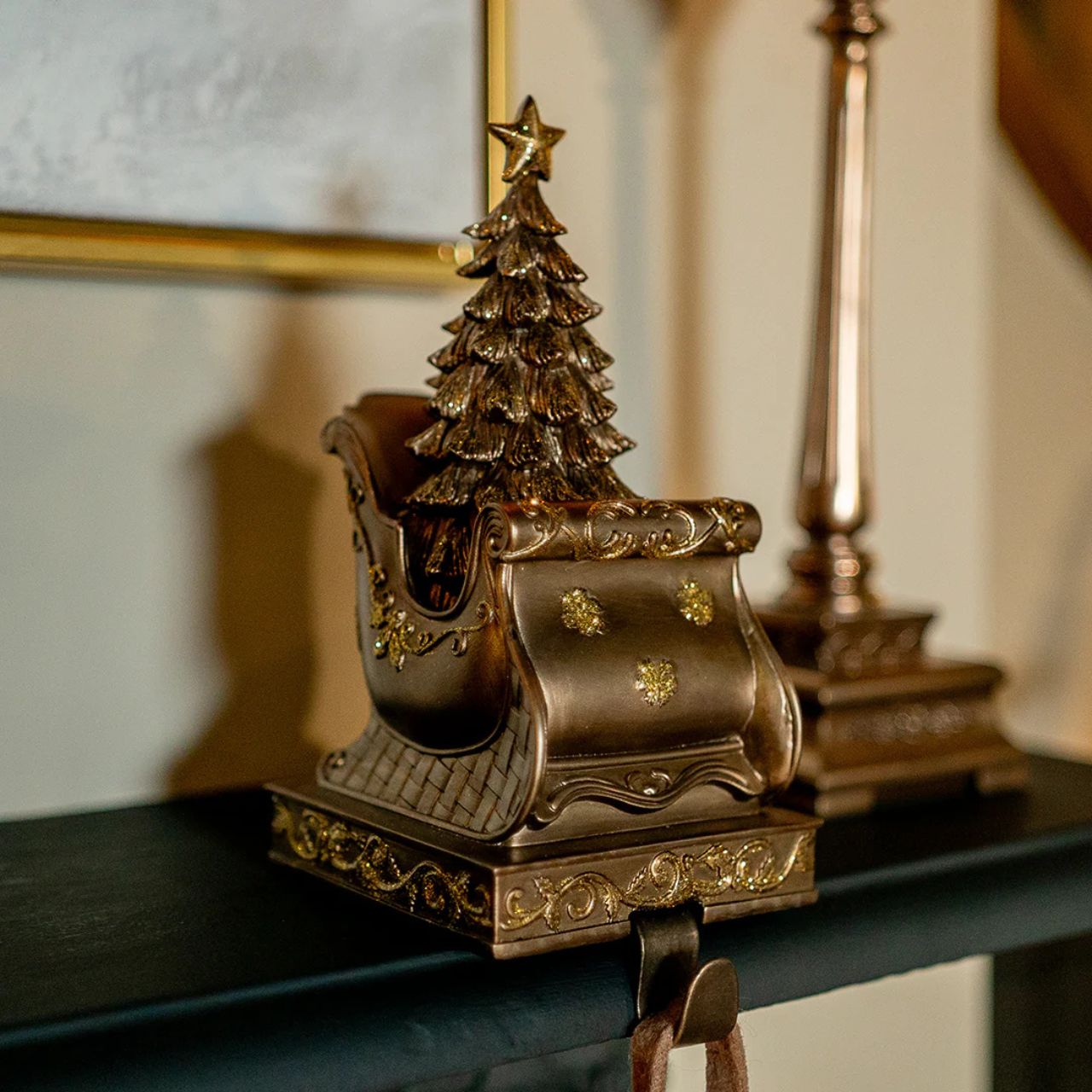 Elevate your holiday décor with our Genesis Christmas Stocking Holder. Crafted with meticulous attention to detail, this elegant piece features Santa's sleigh with a beautifully adorned Christmas tree emerging from its cargo.