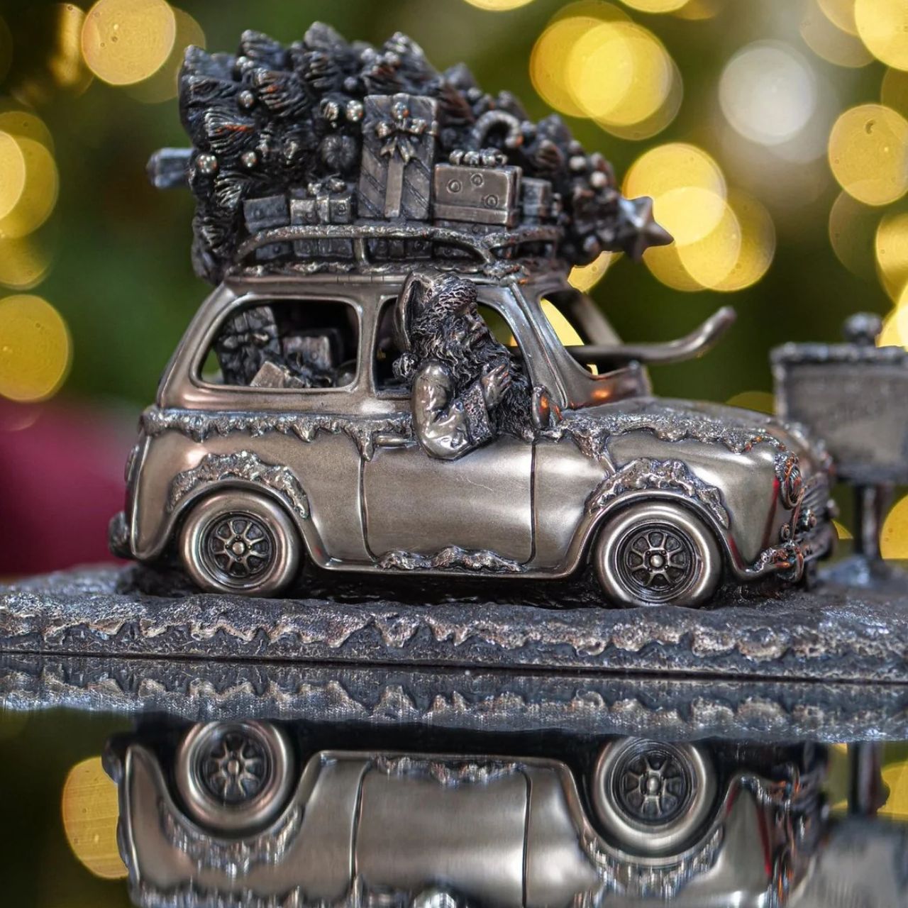 A stunning ornament that is sure to bring festive cheer to your home. This sculpture depicts a Santa driving a car to the north pole with a Christmas tree on the roof.