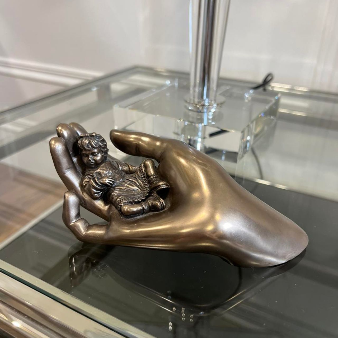 Beautifully crafted in cold cast bronze this wonderful baby figurine from the craftsmen of Genesis Fine Arts depicts the sleeping baby boy carefully curled up in a mothers caring hand.