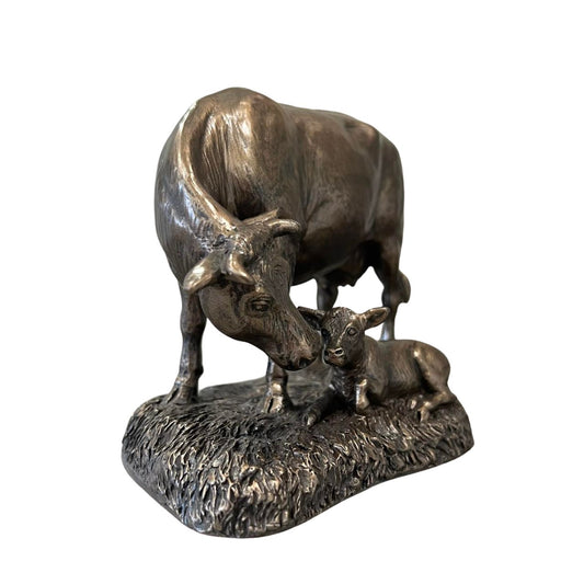 This Genesis Cow and Calf ornament is a rustic farmyard setting cast from bronze.