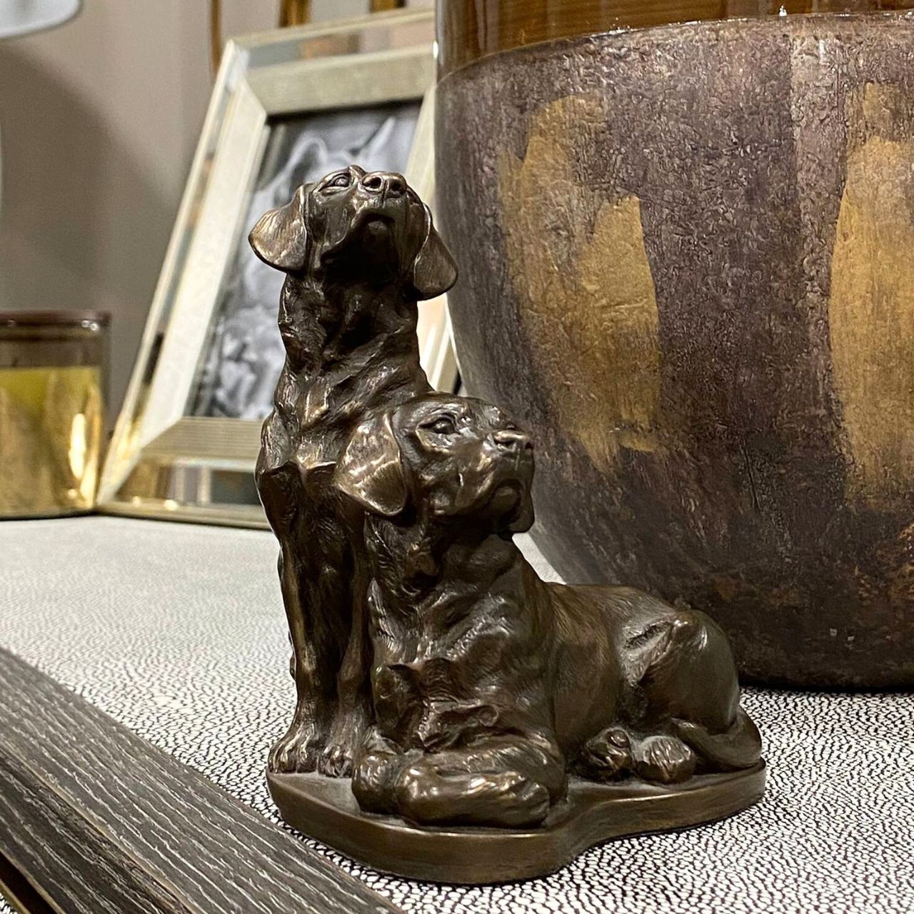 Pair of Labradors sculpture by Genesis Ireland.&nbsp;Bronze coloured and beautifully crafted. this is the perfect gift for the dog lover in your life.