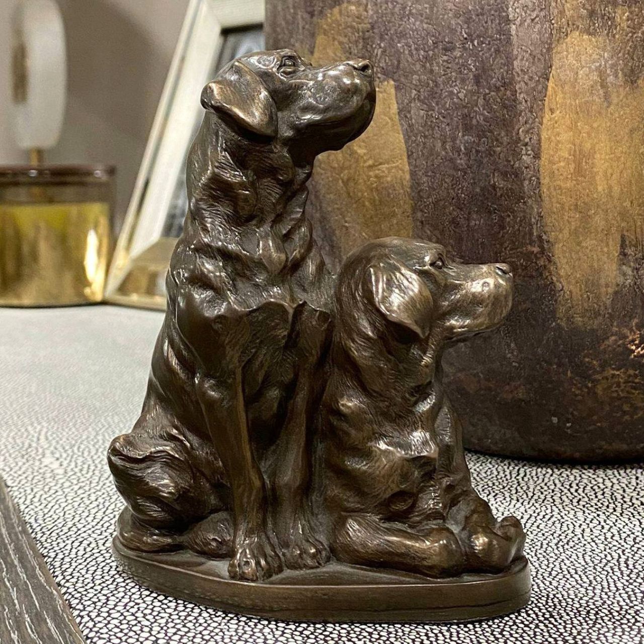 Pair of Labradors sculpture by Genesis Ireland.&nbsp;Bronze coloured and beautifully crafted. this is the perfect gift for the dog lover in your life.