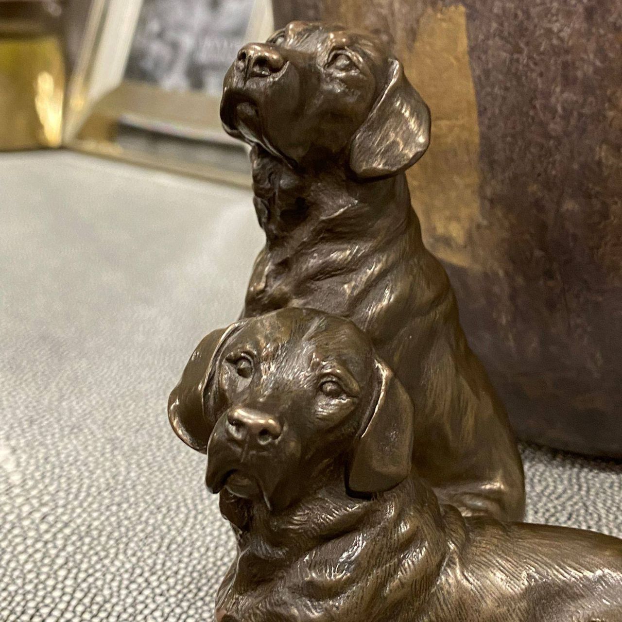 Pair of Labradors sculpture by Genesis Ireland.&nbsp;Bronze coloured and beautifully crafted. this is the perfect gift for the dog lover in your life.