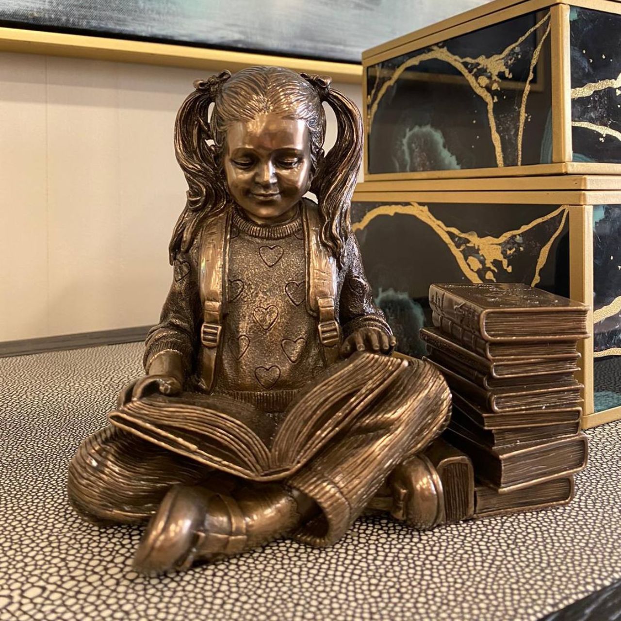 This captivating sculpture embodies the beauty of quiet reflection and the joy found within the pages of literature. It resonates with a sense of curiosity and intellectual curiosity, inviting one to delve into the realms of imagination and knowledge.