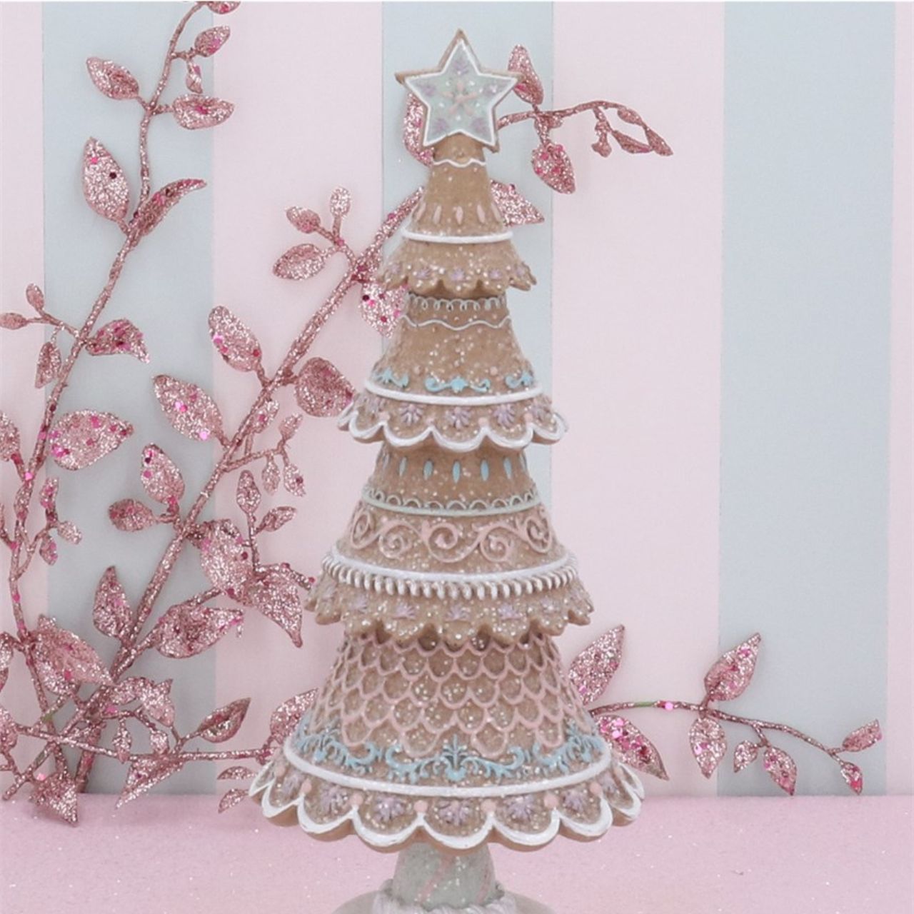 This Pastel Iced Gingerbread Christmas Tree by Gisela Graham stands at 32cm tall and is a delightful addition to any holiday décor. The expertly crafted gingerbread design is finished with a soft pastel icing, adding a touch of whimsy to your home. Elevate your Christmas spirit with this charming tree.