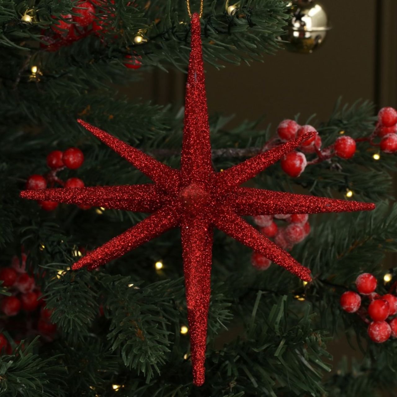 Gisela Graham Red Glitter Bethlehem Star Christmas Hanging Ornament adds a festive sparkle to your holiday tree. This stylish ornament features a beautifully crafted star shape with a sparkly glitter finish that will add a magical touch to your decorations. Designed with long-lasting materials, it is sure to become a treasured addition each year.