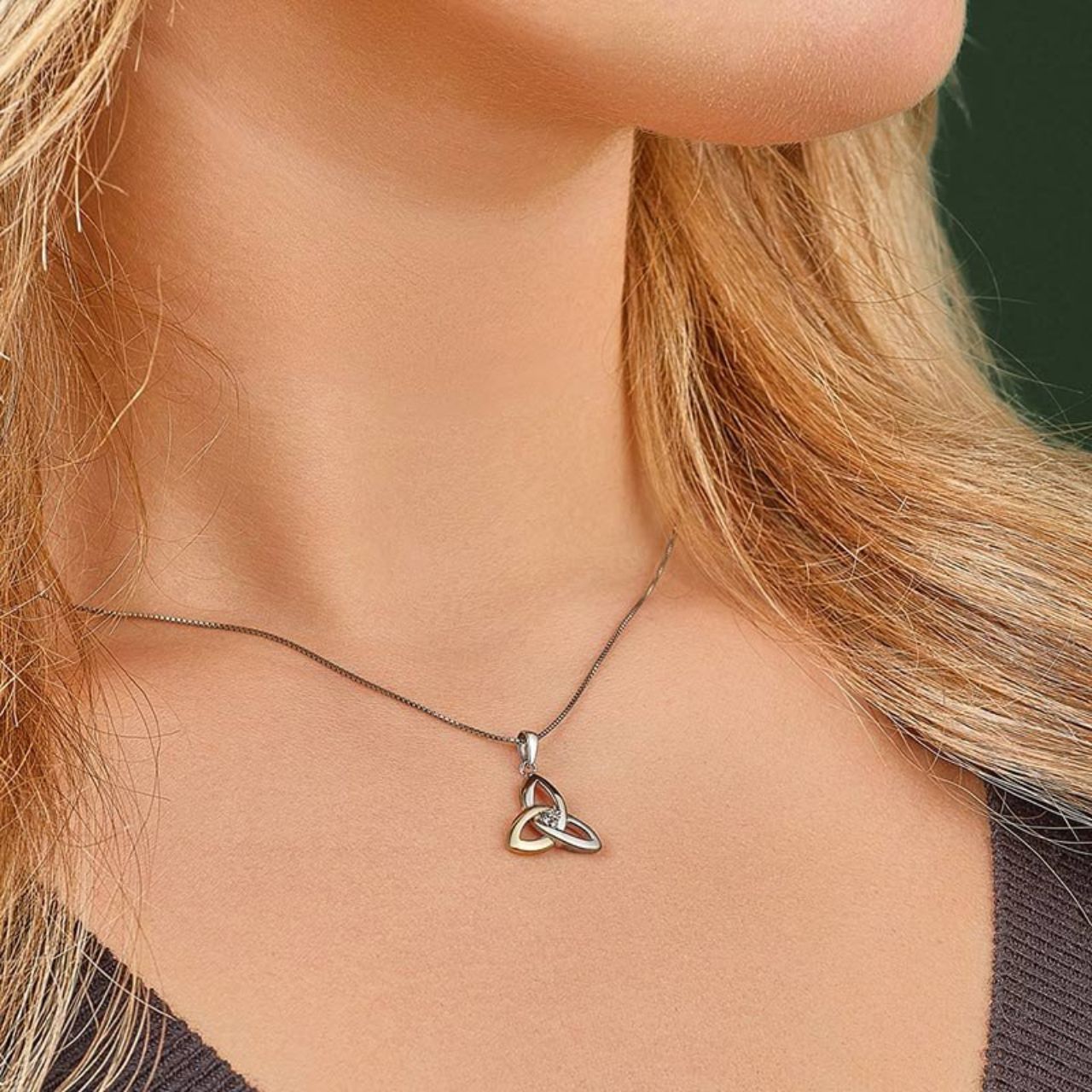 Our beautiful Trinity Knot necklace has been crafted in sterling silver and 10 karat gold, and embellished with a stunning diamond gemstone. The Trinity Knot symbolises eternal love, with no beginning and no end. This piece has been Irish hallmarked in Dublin Castle and would make a perfect gift for someone special.