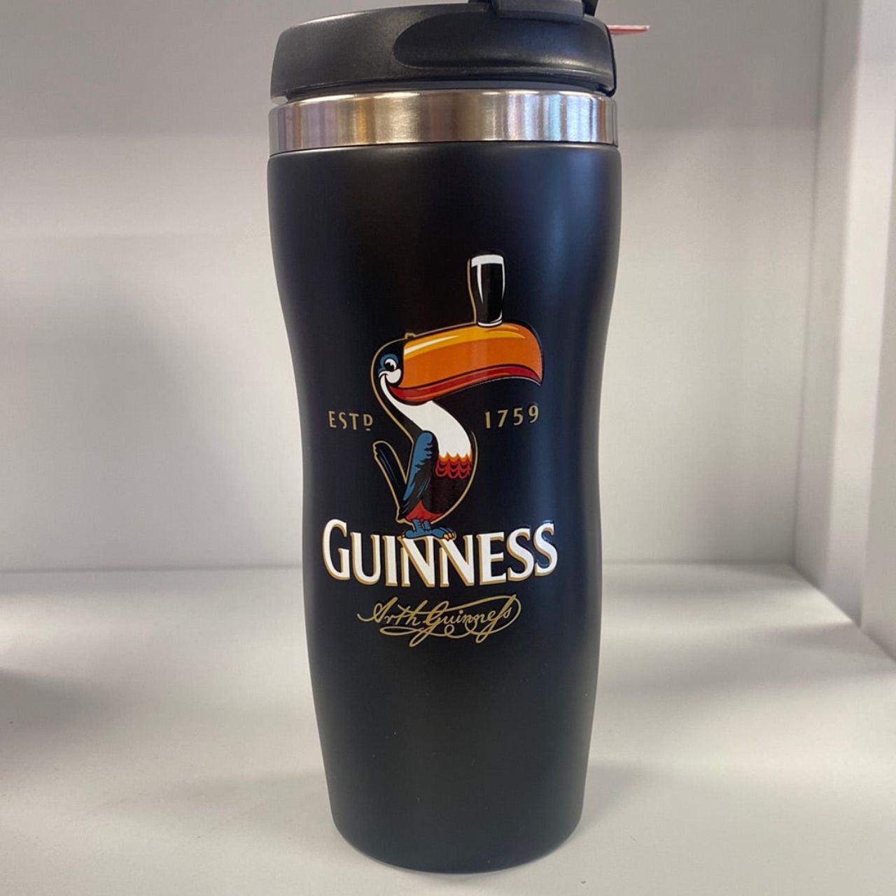 This Guinness Travel Mug Tumbler features a classic Toucan design. Its durable construction makes it perfect for on-the-go use, while its sleek design makes it a stylish accessory. Keep your beverages hot or cold for longer with this high-quality travel mug.