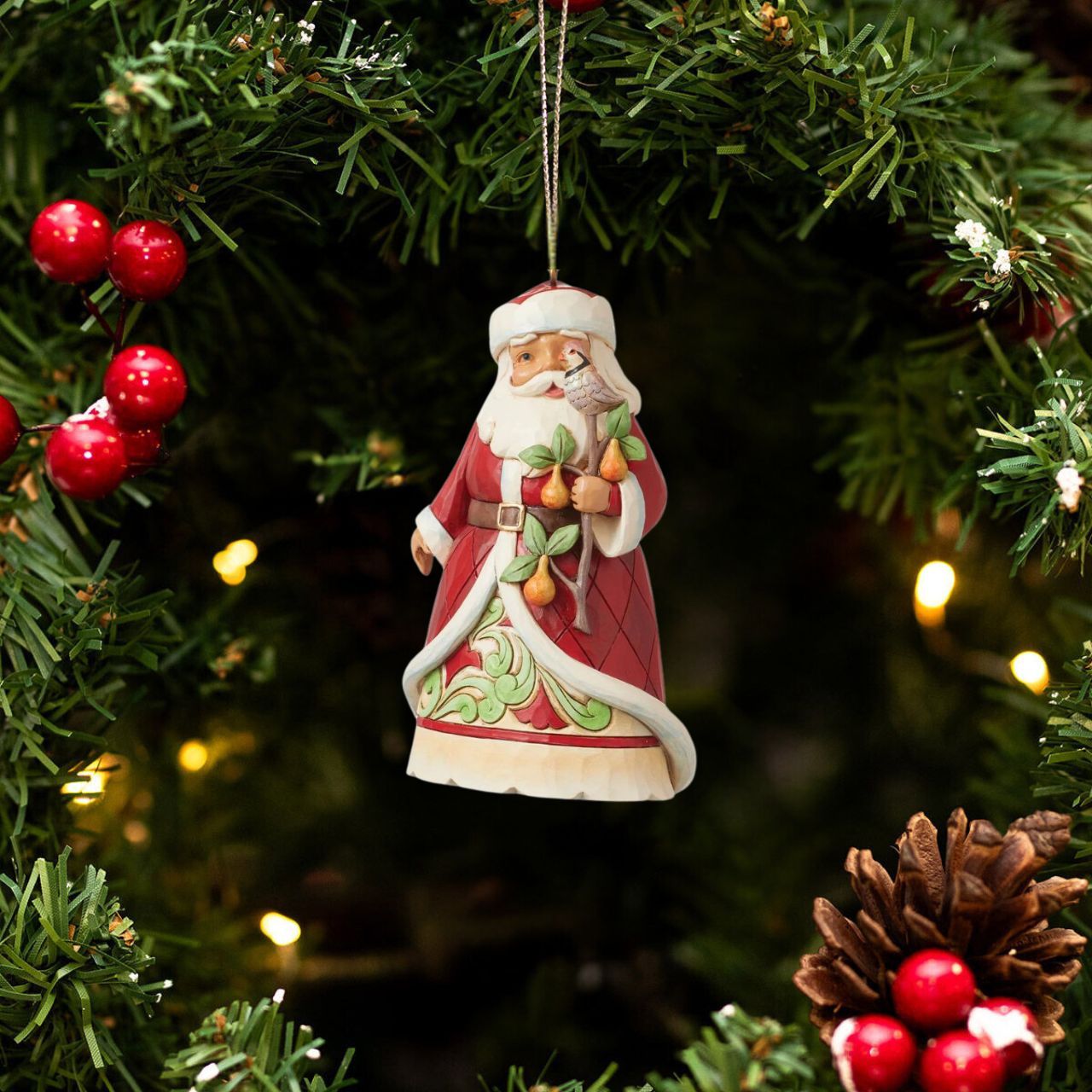 Designed by award winning artist Jim Shore as part of the Heartwood Creek 2023 World Wide Event, hand crafted using high quality cast stone and hand painted, this Santa holding a Partridge in a Pear Tree Hanging Ornament is perfect for the Christmas season.