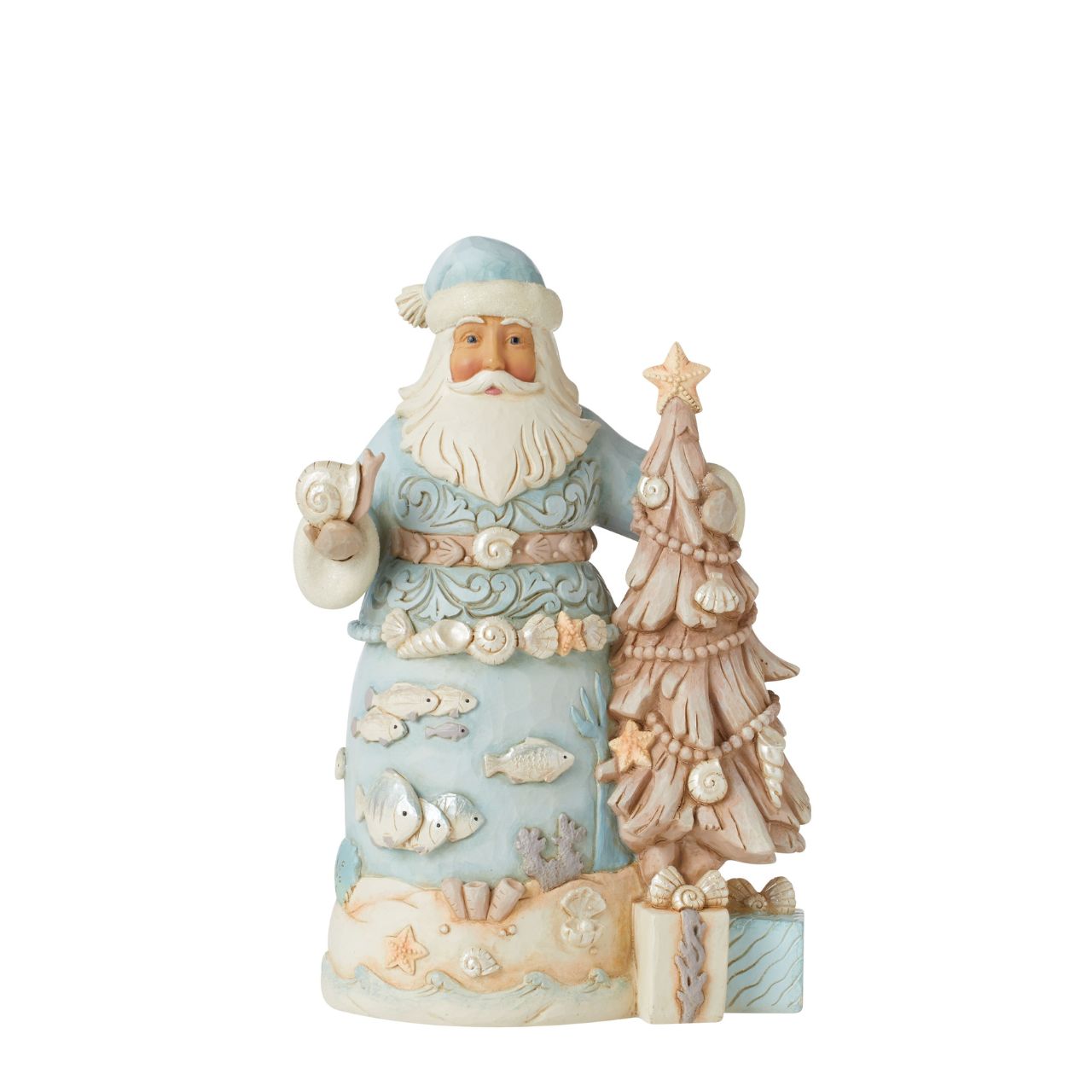 The joy of Christmas festivities meets the relaxing calm of the sea in this Costal Collection for Heartwood Creek by Jim Shore. This stunning Santa in blue adorned with shells and coral is truly delightful.