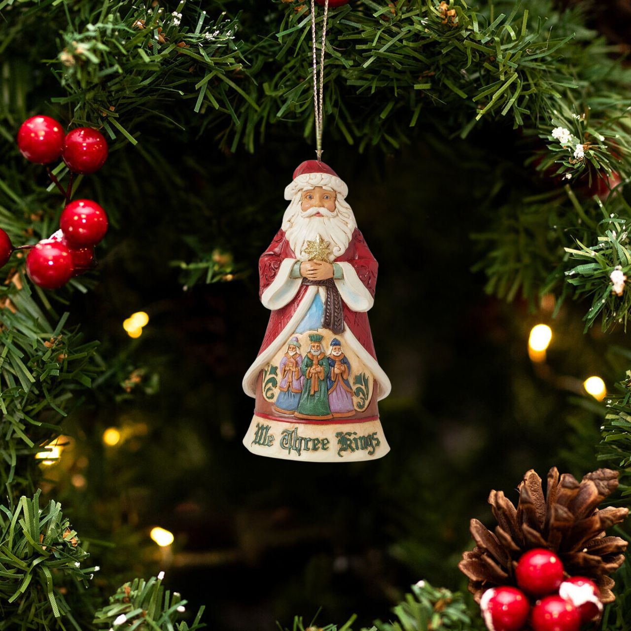 This 17th Annual Santa ornament by Jim Shore is of a series honouring Christmas songs. Three lavishly dressed kings create a colourful manger scene on Santa's robes. Santa sings along to We Three Kings emphatically, hands in gesturing in his ornate coat.