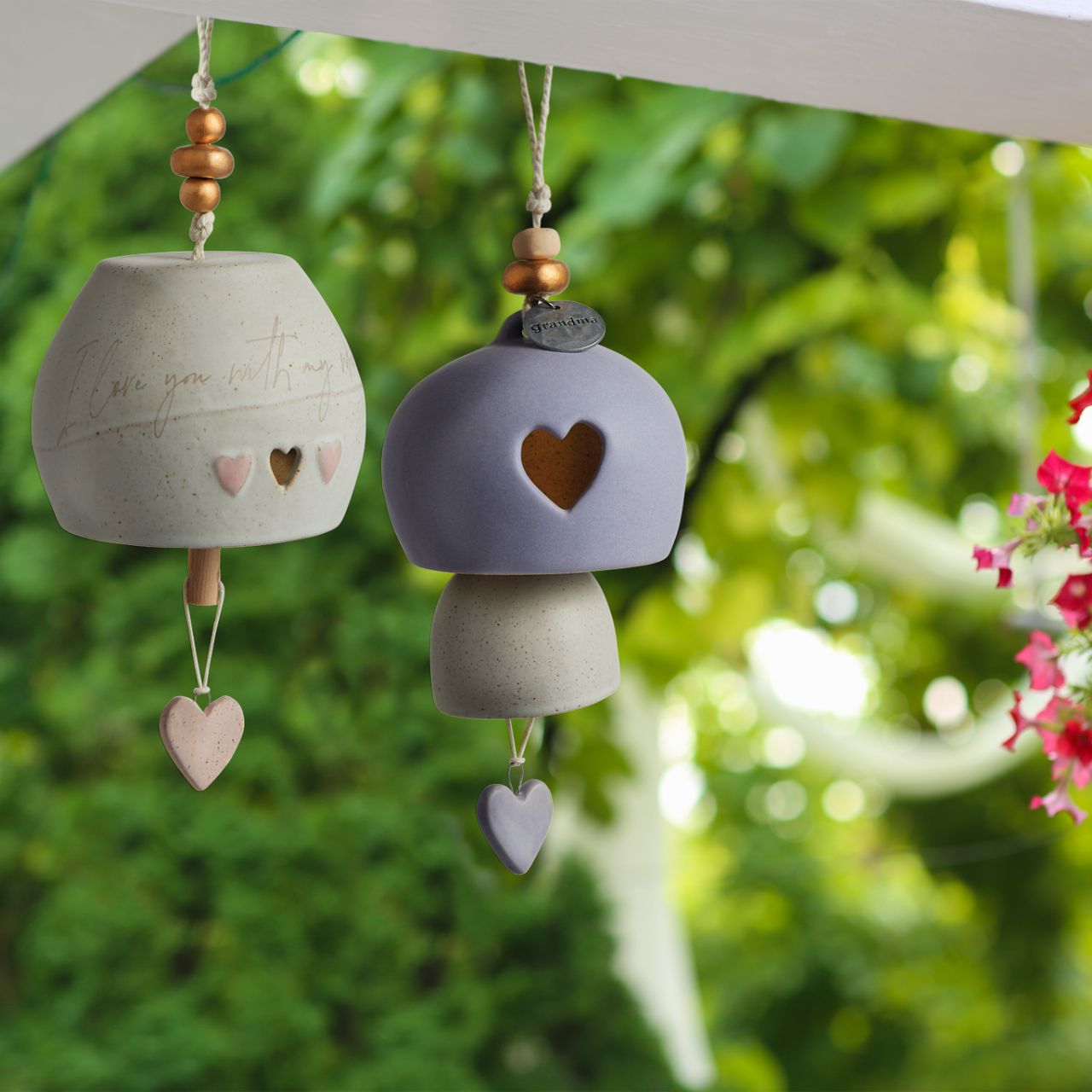 Give beauty and relaxation with our Inspired Bells collection, a selection of artisan bells in soft, serene colours with soothing, gentle rings bearing sentiments of faith and love. Our Inspired Bell - Grandma is a ceramic indoor/outdoor bell in lavender and white with a heart pull and a heart cut out.