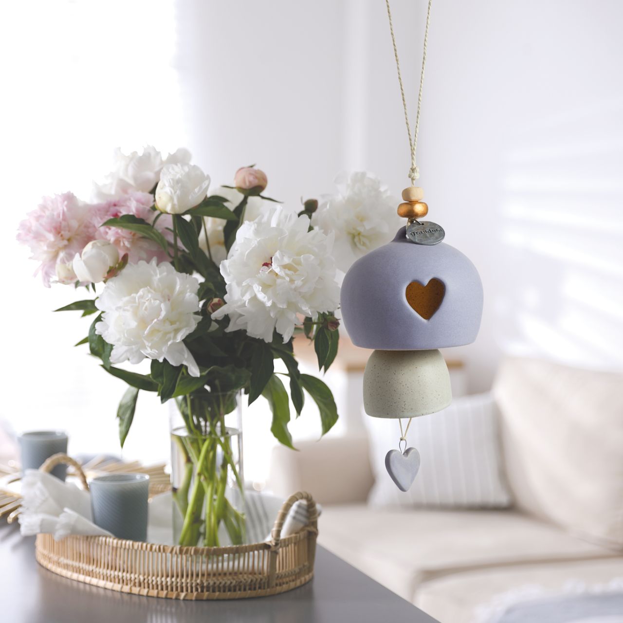 Give beauty and relaxation with our Inspired Bells collection, a selection of artisan bells in soft, serene colours with soothing, gentle rings bearing sentiments of faith and love. Our Inspired Bell - Grandma is a ceramic indoor/outdoor bell in lavender and white with a heart pull and a heart cut out.