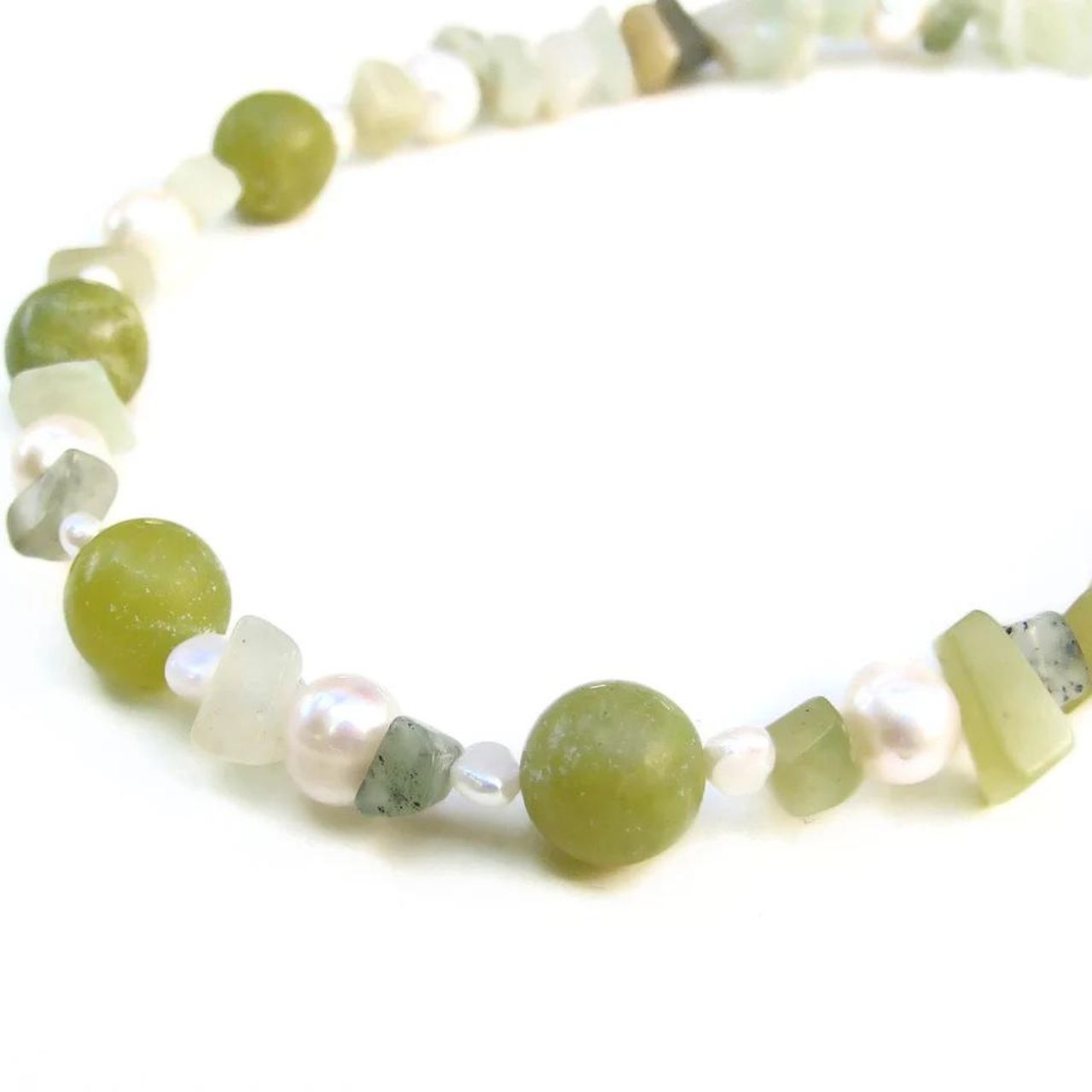 Jade has long been treasured especially in the East for jewellery, statues and trinkets. Its soft green lustre combines beautifully with natural Freshwater Ivory Pearls. This necklace uses a mixture of round Jade beads with a multitude of delightfully irregular chips.