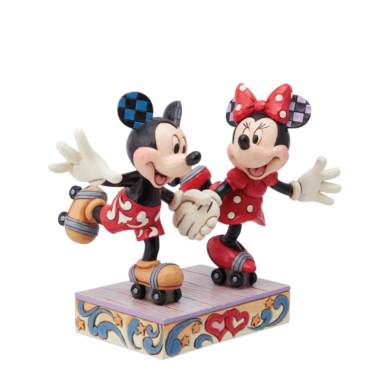 Introducing the newest addition to the Disney Traditions collection by Jim Shore - the Mickey and Minnie Mouse Roller Skating figurine] With exquisite attention to detail and impeccable craftsmanship, this high-quality piece is a must-have for any Disney fan and collector. Mickey and Minnie Mouse are arguably the most iconic couple in the Disney universe, and this figurine captures them in their element - roller skating together hand in hand.