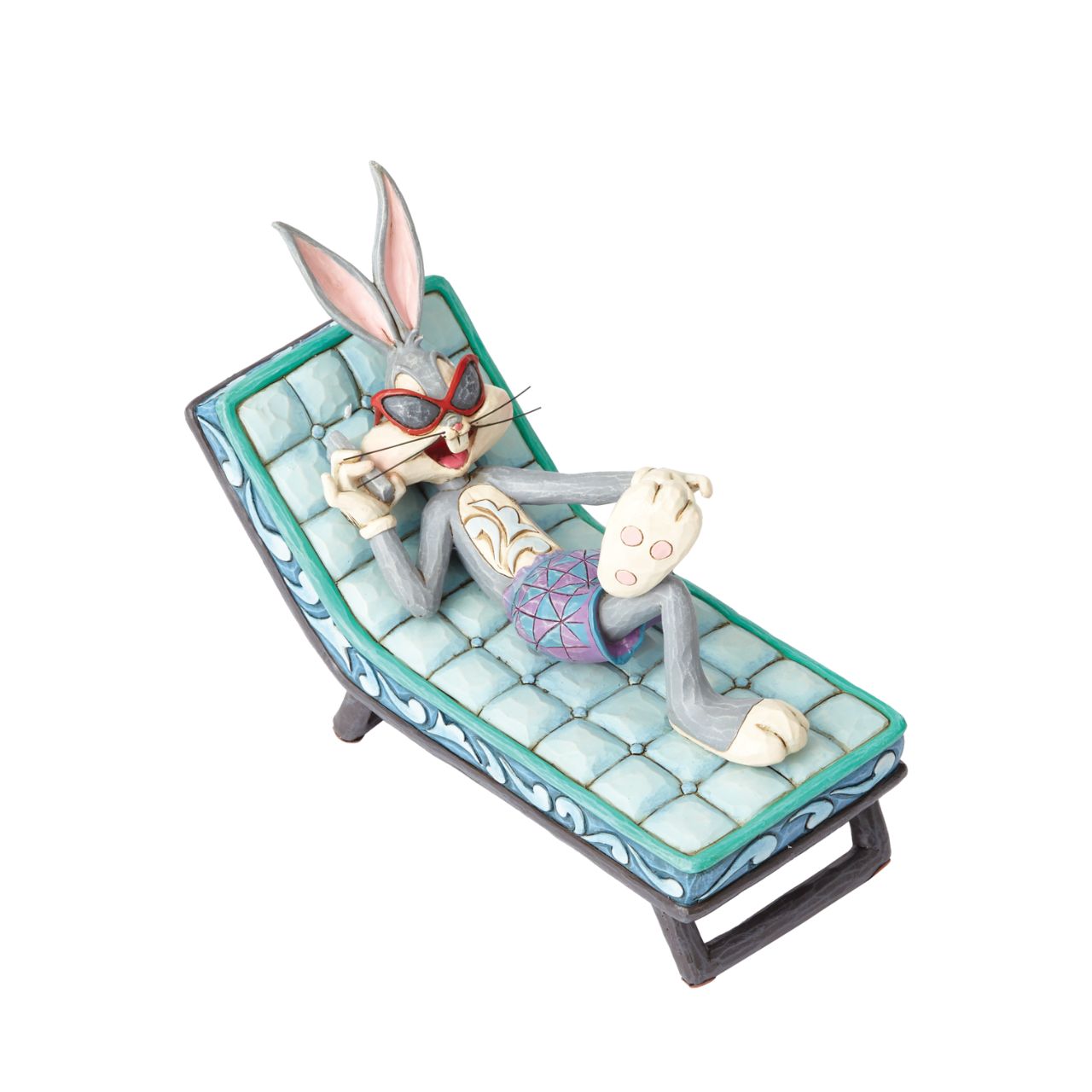 Movie mogul Bugs Bunny catches some rays in this whimsical scene from Looney Tunes. Handcrafted in rich detail, this poolside rabbit is beautifully decorated with the quilt patterns and folk-art style that are unmistakably Jim Shore.