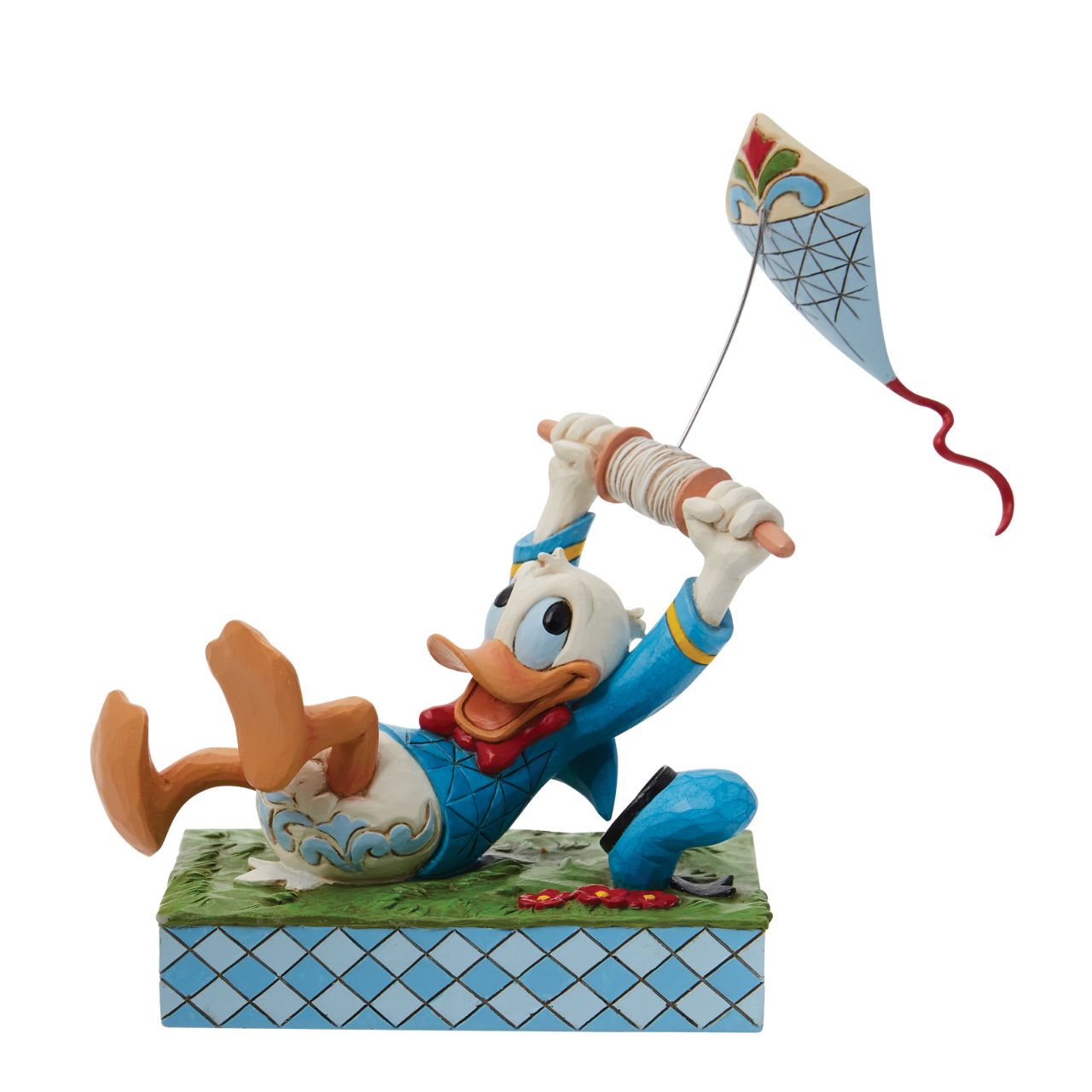 A fun piece from Jim Shore as part of his Disney Traditions collection is this Donald Duck flying a kite figurine. With a look of pure joy as his kite pulls him along, Donald is having lots of fun. As his hat also bumps along the ground, you get the true sense of movement and action in this piece.