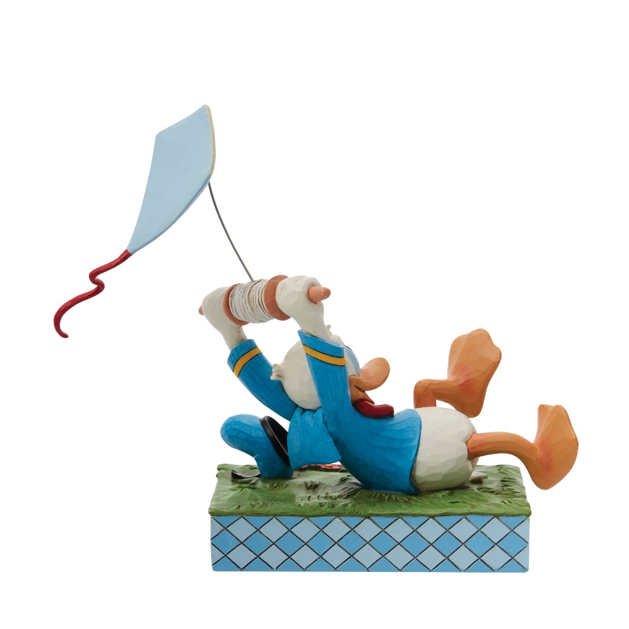 A fun piece from Jim Shore as part of his Disney Traditions collection is this Donald Duck flying a kite figurine. With a look of pure joy as his kite pulls him along, Donald is having lots of fun. As his hat also bumps along the ground, you get the true sense of movement and action in this piece.