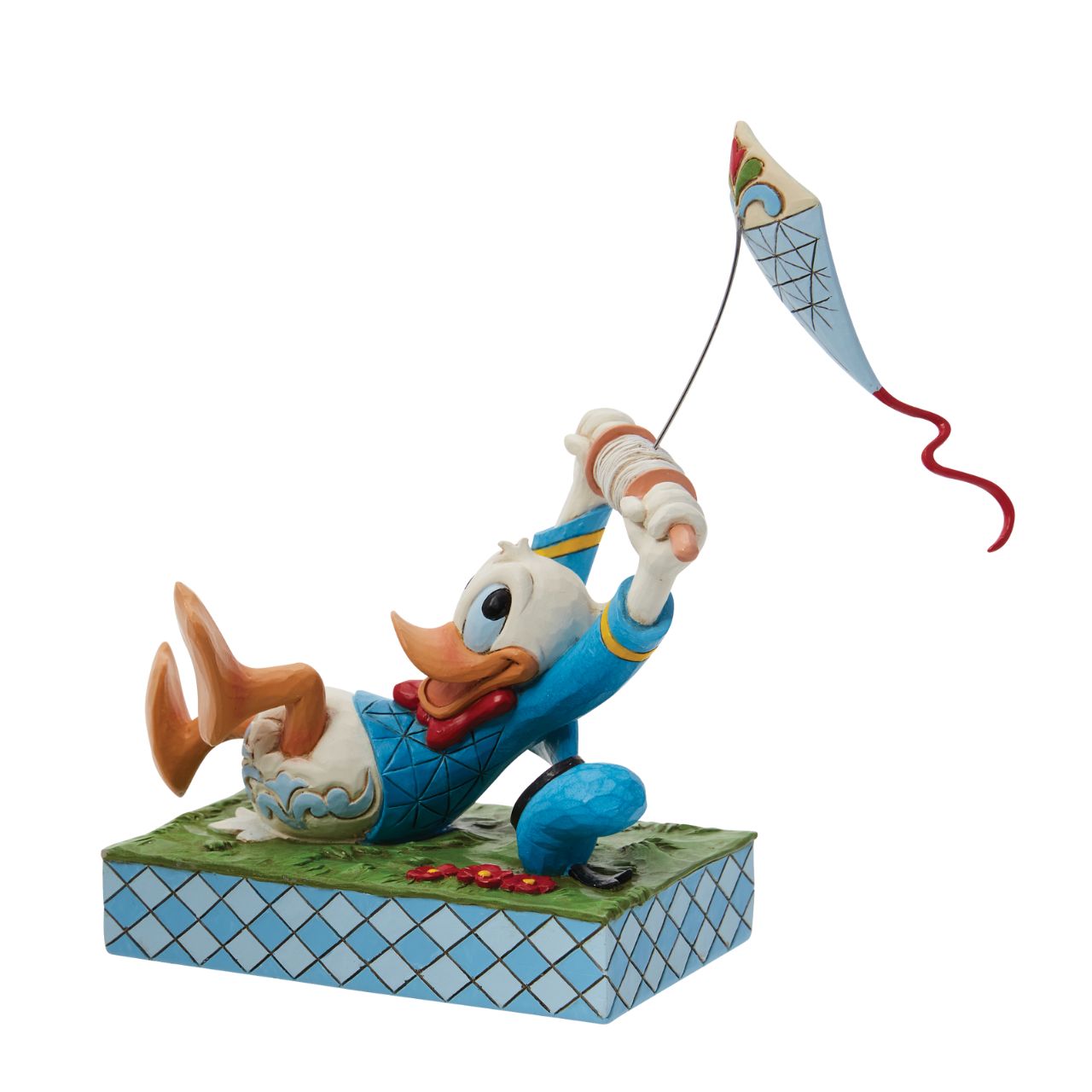 A fun piece from Jim Shore as part of his Disney Traditions collection is this Donald Duck flying a kite figurine. With a look of pure joy as his kite pulls him along, Donald is having lots of fun. As his hat also bumps along the ground, you get the true sense of movement and action in this piece.