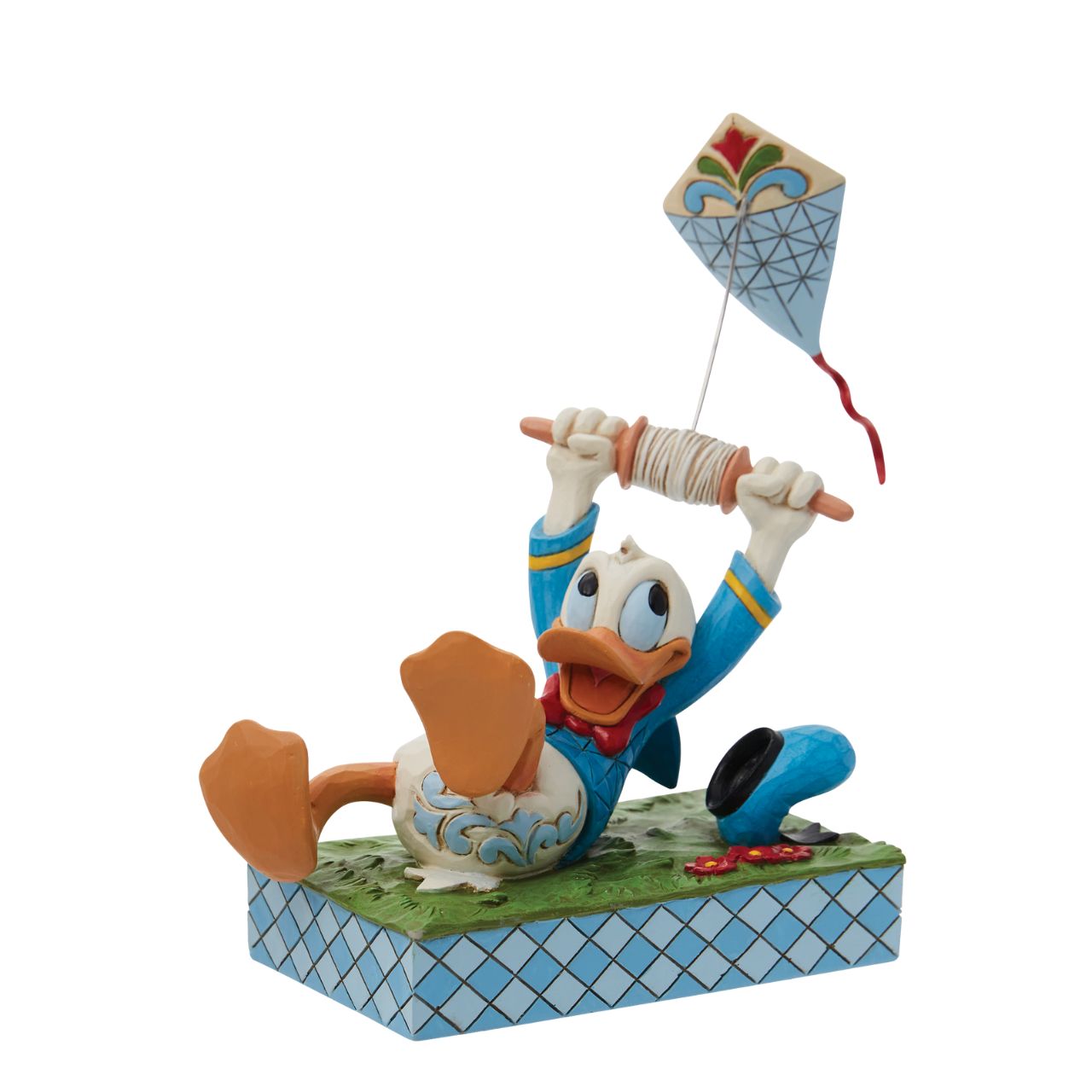 A fun piece from Jim Shore as part of his Disney Traditions collection is this Donald Duck flying a kite figurine. With a look of pure joy as his kite pulls him along, Donald is having lots of fun. As his hat also bumps along the ground, you get the true sense of movement and action in this piece.