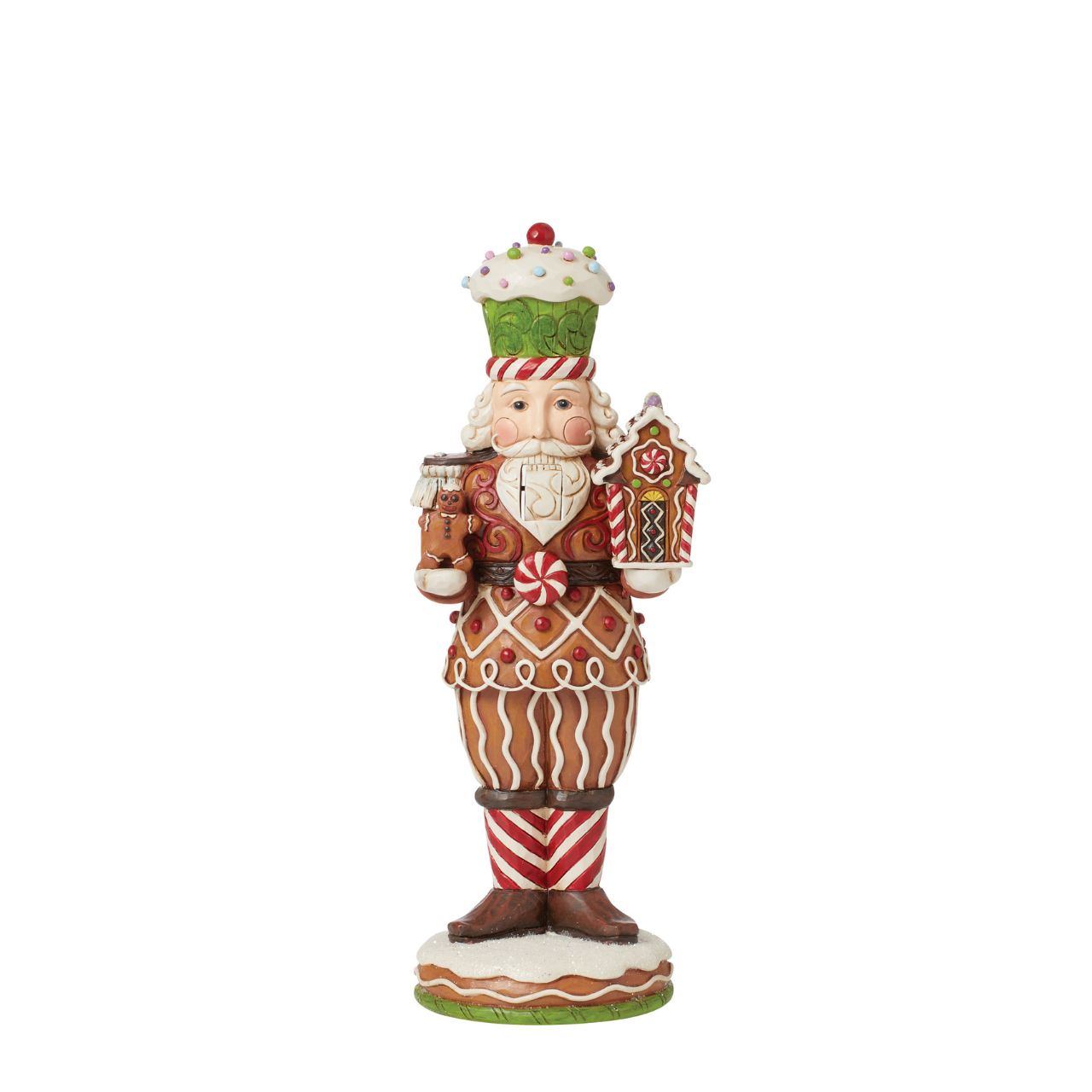 This Santa nutcracker from Jim Shore wears a coat modelled off candy canes. With stripes, frosting rosemaling, and sprinkles, Santa's uniform is buttoned with a peppermint candy. With a cupcake cap and rosy cheeks, nutcracker Santa holds gingerbread.