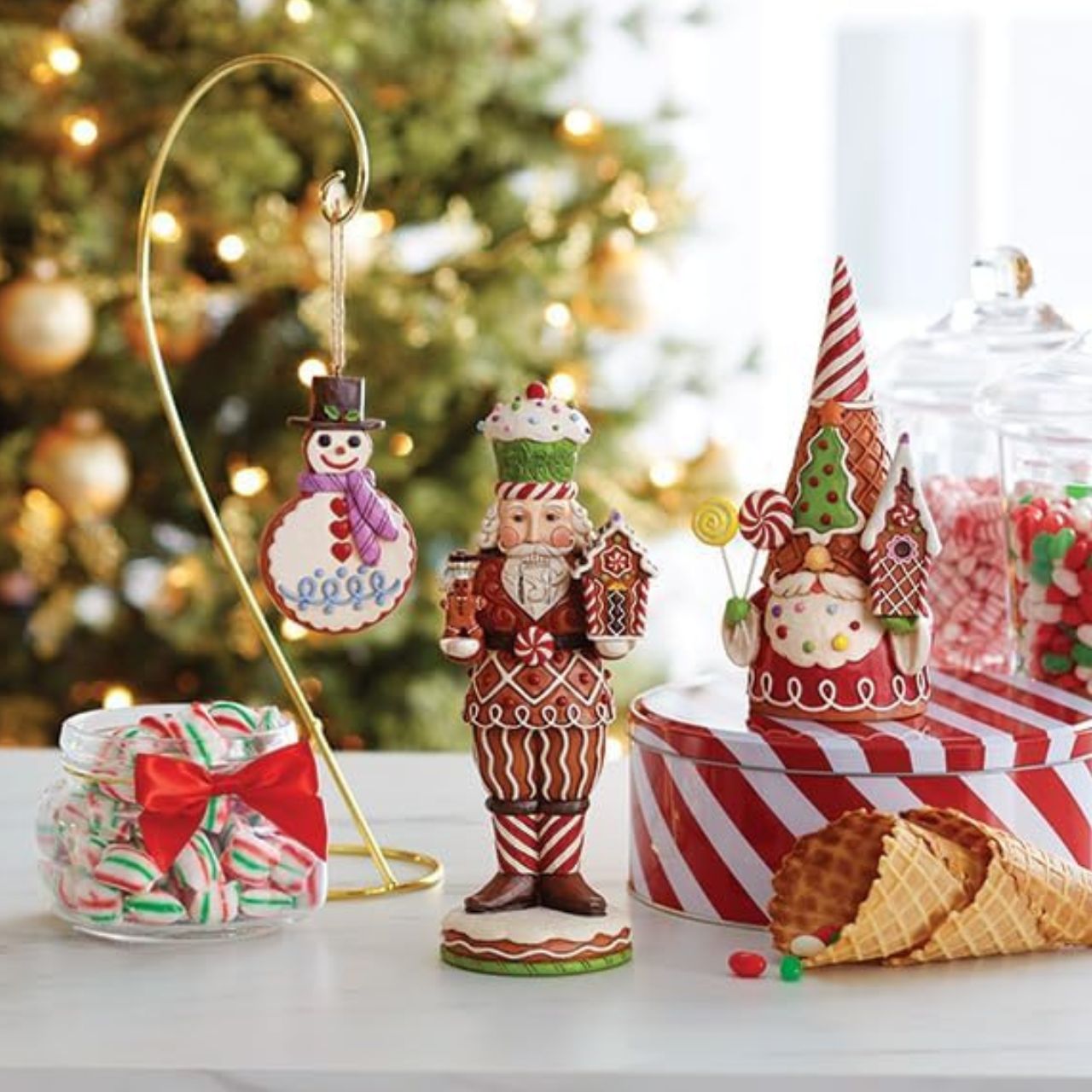 This Santa nutcracker from Jim Shore wears a coat modelled off candy canes. With stripes, frosting rosemaling, and sprinkles, Santa's uniform is buttoned with a peppermint candy. With a cupcake cap and rosy cheeks, nutcracker Santa holds gingerbread.