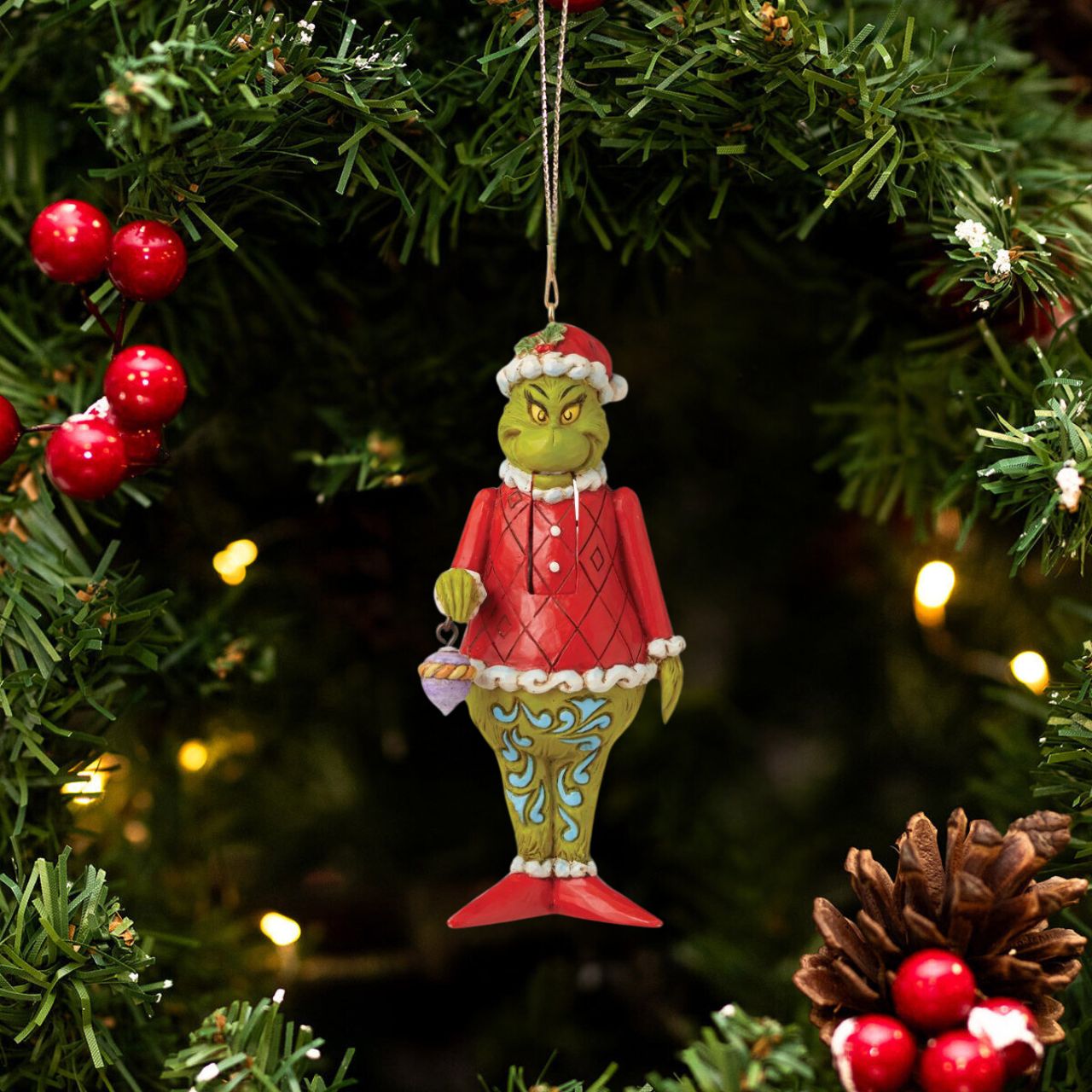 Marrying two beloved holiday figures, Jim Shore creates a bauble that captures the Grinch in all his glory. With holly brimmed in his Santa hat, no one dares kiss this Christmas Nutcracker for fear of being cracked across the face.