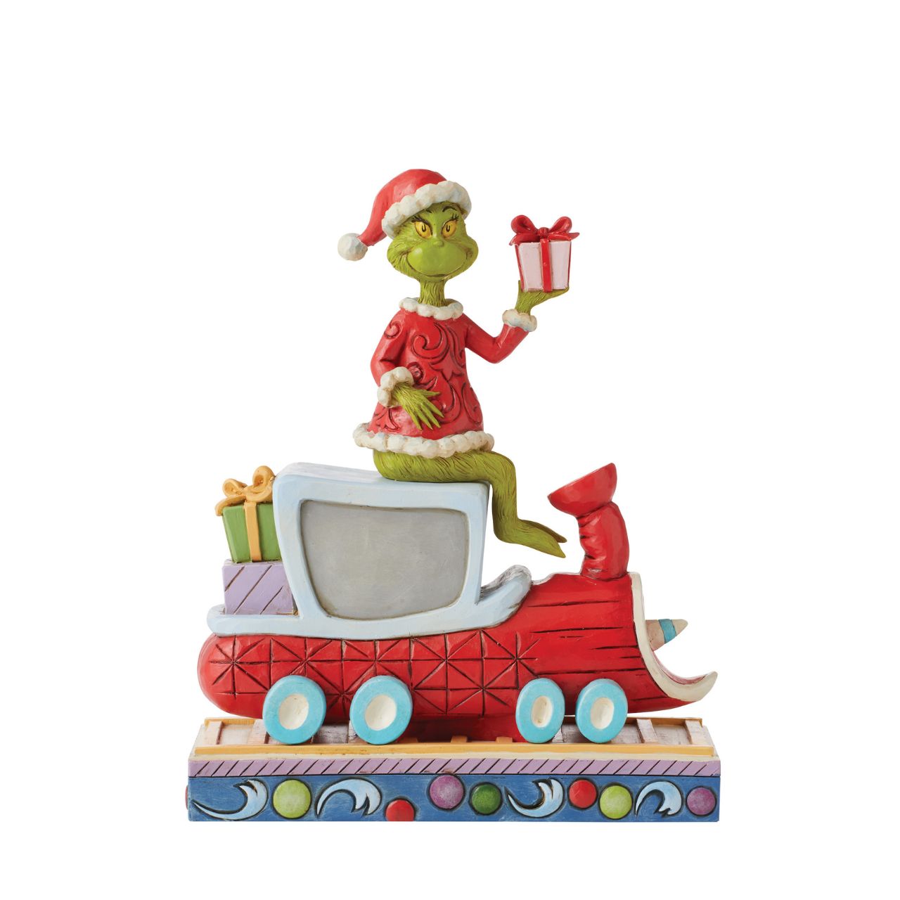 Atop a red train engine bound for Whoville, The Grinch wears a dashing red vest and Santa hat to re-deliver previously stolen presents. Finding kindness in his heart, the greedy Grinch changes his disposition and wears a sincere smile in this Jim Shore collectable.