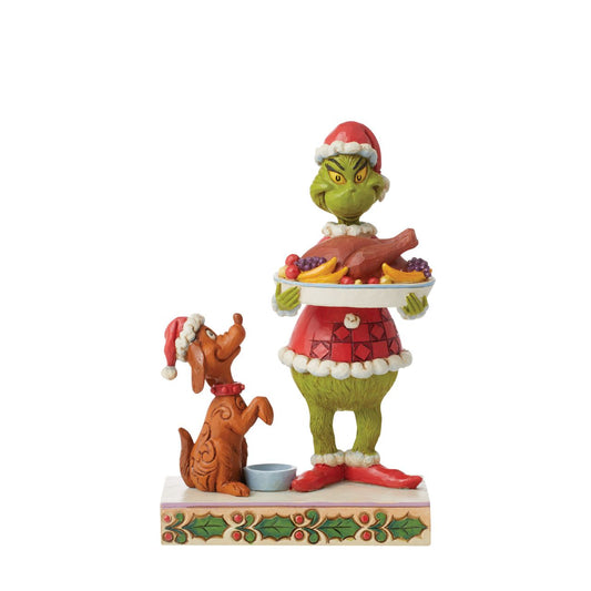 Dressed as Santa, the Grinch has prepared a spectacular Christmas feast for himself and best friend, his loyal dog, Max. Wearing Santa hat, Max sits pretty, patiently waiting for a turkey leg. This bright bust is masterly crafted by Jim Shore.